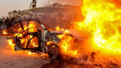 Flames engulf a car belonging to Palestinian journalist Mohammed Washeha in southern Gaza city. Broadcaster Al Jazeera said Washeha was killed by an Israeli drone attack. AFP