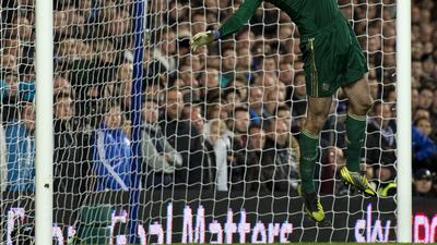 Chelsea goalkeeper Petr Cech tips away the ball against Manchester United. Adrian Dennis/AFP
