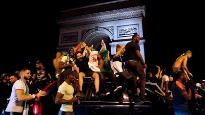 Algeria's supporters celebrate in front of the Arc de Triomphe on the Champs Elysee Avenue in Paris. AFP