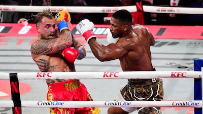 Anthony Joshua, right, and Jake Paul during their heavyweight bout at the Kaseya Centre, in Miami, Florida, on December 19. Joshua put Paul on the canvas with a sixth-round knockout. PA