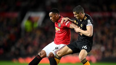 Anthony Martial of Manchester United, left, holds off a challenge from Conor Coady of Wolverhampton Wanderers. Getty