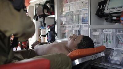 A Palestinian young man, who was shot and wounded by Israeli troops after he had stabbed a soldier, is evacuated in an ambulance after the incident near the “Bel” crossing on motorway 443 near the West Bank village of Beit Ur, west of Ramallah on August 15. AFP Photo