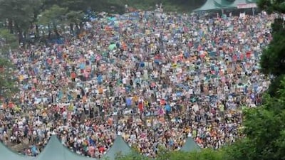 Crowds fill a forest in the Japanese resort of Naeba for the 2010 edition of Fuji Rock Festival. Diva Zappa / Corbis