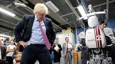 Britain's Foreign Secretary Boris Johnson looks at a bipedal humanoid robot Wabian2 at Research Institute for Science and Engineering at Waseda University's Kikuicho Campus in Tokyo, Japan July 20, 2017. REUTERS/Eugene Hoshiko/Pool TPX IMAGES OF THE DAY