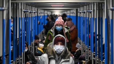 A woman wearing a face mask to protect against the coronavirus disease rides in a metro train in Moscow. Russia confirmed 26,190 new Covid-19 cases on December 9. AFP