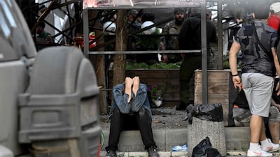 A man reacts as rescuers and volunteers work to extricate people from under the rubble after a Russian missile strike hit a restaurant in Kramatorsk, eastern Ukraine. AFP