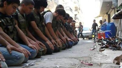 Free Syrian Army fighters pray in a street in Aleppo's Salaheddine neighbourhood.