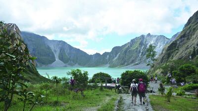 People walking to Pinatubo Crater in Philippines. Getty Images