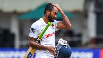 Sri Lanka captain Dimuth Karunaratne walks back to the pavilion after his dismissal. AFP
