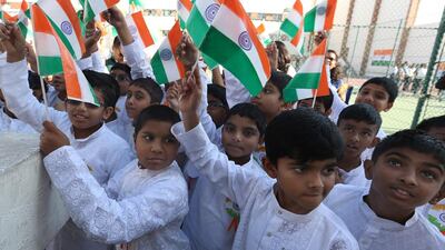 Pupils at Abu Dhabi Indian School raise their flags in honour of Republic Day. Delores Johnson / The National