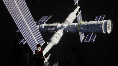 A child stands near a giant screen showing the images of the Tianhe space station at an exhibition featuring the development of China's space exploration on the country's Space Day at China Science and Technology Museum in Beijing. Reuters