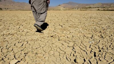 A Pakistani villager walks on the cracks of the dry Hanna Lake in the Urak Valley. A UN report has said that the earth is facing an unprecedented crisis due to global warming, which was addressed at this week's COP24 summit. AFP