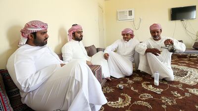 Dubai, United Arab Emirates-May,14, 2015: ( Second from Right) Ahmedullah Rahman former camel jockey with brothers Rashed Al Kitbi and Butti Al Kitbi pose during the The former camel jockey, Ahmuduallah Rahman, second from right, with brothers Rashed Al Kitbi and Butti Al Kitbi at their farm near Al Khawaneej in Dubai. Satish Kumar / The National