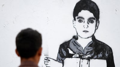 A passer-by looks at Haifa Subay's mural 'Just a leg' in Sanaa. Mohamed Al Sayaghi / reuters