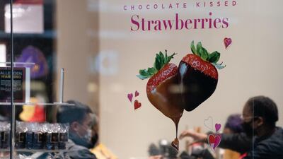 Customers and employees are seen in a Godiva chocolate store in Atlanta, Georgia. AFP