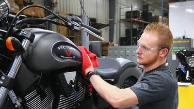 A worker puts finishing touches on a 2015 Victory Gunner motorcycle. Gunner features a 106-cubic inch engine and a four-valve per cylinder powertrain producing 110 foot-pounds of torque. Scott Olson / Getty Images / AFP