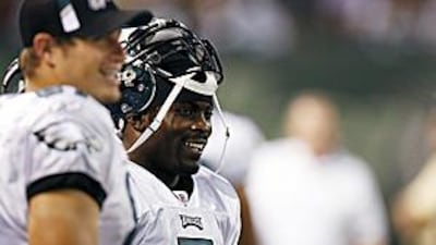 Michael Vick laughs on the sidelines after rushing for a touchdown in the second quarter during a pre-season game against the New York Jets on September 3.