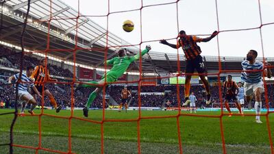 Dame N'Doye of Hull City scores past Queens Park Rangers keeper Robert Green to score the winner in a 2-1 Premier League victory on Saturday at the KC Stadium. Nigel Roddis / Getty Images