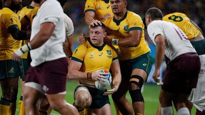 Australia's flanker Jack Dempsey, centre, is congratulated after scoring a try. AFP