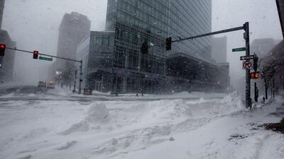 Streets and sidewalks are seen covered in snow as winter storm Juno continues to move through Boston, Massachusetts, U.S., on Tuesday, Jan. 27, 2015. Snow will fall across eastern Massachusetts for the next several hours as the blizzard that missed New York buries much of New England, shutting down transportation and knocking out power to thousands of consumers and to Entergy Corp.'s Pilgrim nuclear plant. Photographer: Scott Eisen/Bloomberg