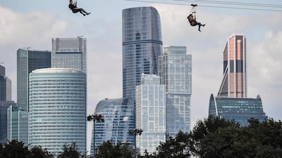 FEDERATION TOWER, MOSCOW, 373 metres: People slide along a zipline over the Moskva river in front of Moscow's financial district, with Federation Tower in the centre. Construction began in 2005, but the financial downturn meant it was not completed until 2017. The original design included a spire that would have taken the height to 450 metres, but this was dismantled before completion. AFP