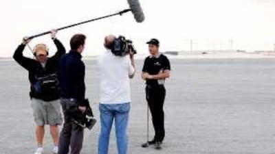 Padraig Harrington speaks to a television crew, in the UAE.