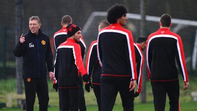 David Moyes of Manchester United jokes with his players during Tuesday's training session. Laurence Griffiths / Getty Images / March 18, 2014
