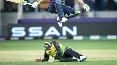 England's Jos Buttler jumps over Australia's Steve Smith during their T20 World Cup at the Dubai International Stadium on Saturday, October 30, 2021. EPA