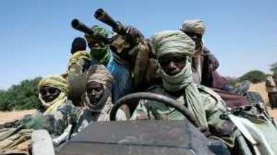 A file picture showing fighters of the Sudanese Justice and Equality Movement (JEM) driving their battlewagon through an area on the Sudan-Chad border in northwest Darfur.