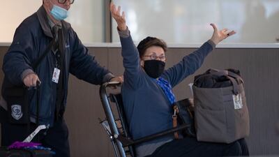 Ank Dow from the Netherlands greets her family after she passed through the US Customs and Border Protection gate at Boston's Logan International Airport. EPA