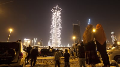 People watch the Burj Khalifa's fireworks display from afar on New Year 2012. Jaime Puebla / The National
