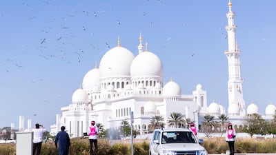 Pink Caravan riders at Sheikh Zayed Grand Mosque in Abu Dhabi.