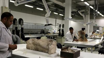 Archaeologists renovate artifacts at the Grand Egyptian Museum in Giza. Mohamed Abd El Ghany / Reuters