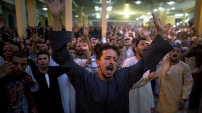 Coptic Christians shout slogans during a funeral service for victims of a bus attack, at Abu Garnous Cathedral in Minya, Egypt. Amr Nabil / AP Photo