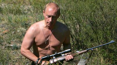 Putin carries a hunting rifle in the Republic of Tuva on August 15, 2007. AFP