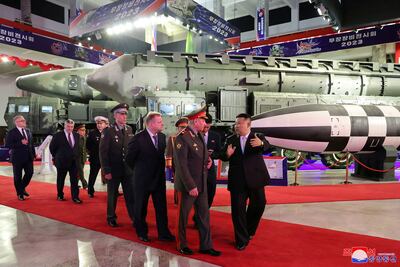 Kim Jong-un shows Sergey Shoigu around an exhibition of military equipment during his visit to North Korea in July. Reuters