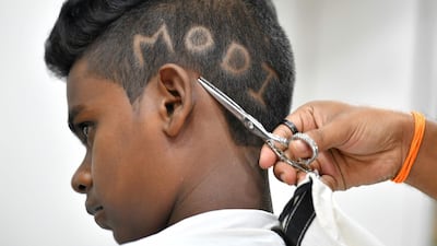 A young boy gets a Modi haircut. AFP