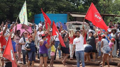 Members of the national landless movement protest next to a railroad used to transport iron ore from the mining company Vale SA. AP