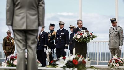 Britain's ambassador to France, Edward Llewellyn lays flowers at the international ceremony marking the 76th anniversary of the World War II Allied landings in Normandy. AFP