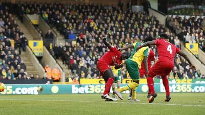 Dieumerci Mbokani scores the 1-1 equaliser for Norwich City on a backwards kick against Liverpool. John Sibley / Action Images / Reuters