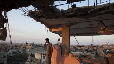 Mohammed Atash stands on the top floor of his home as he overlooks the destruction in Shujayea at dawn. His family’s home was hit by a warning rocket and the family of 40 people fled. When they returned they discovered their home had been heavily damaged during the fighting.