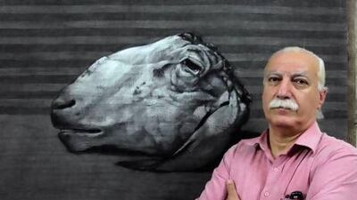 Syrian artist Youssef Abdelke in front of one of his works at his atelier in Damascus in this September 23, 2010 file photo.
