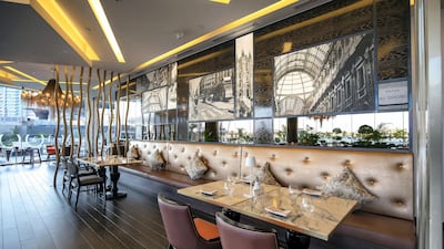 The decor has pops of greenery and statement chandeliers, plus outdoor seating