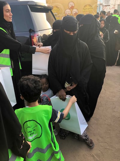 Volunteers from Live to Give distribute Eid gifts in less privileged neighbourhoods in Jeddah. Mariam Nihal / The National
