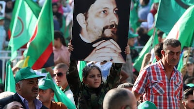 Amal Movement supporters hold images of Imam Musa Al Sadr at an event held in the Lebanese town of Baalbeck in 2018. AFP