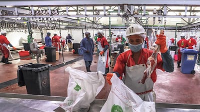 Workers bag the cut meat for delivery to customers.