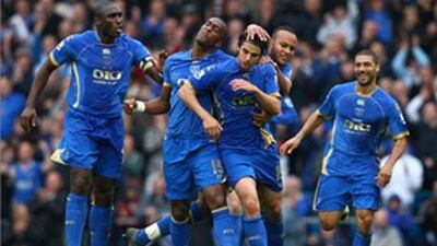 Portsmouth teammates celebrate after scoring a goal during a match against West Bromwich Albion in April this year.