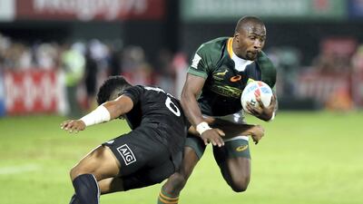 Siviwe Soyizwapi of South Africa is tackled by Ngarohi McGarvey-Black of New Zealand at The Sevens. Chris Whiteoak / The National