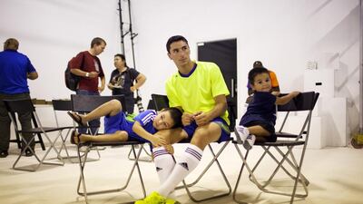 Sebastian Tagliabue is never far from his two sons Facundo, 5, left, and Gustavo, 2, neither of whom were born in his naive Argentina. Christopher Pike / The National