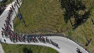 Cyclists ride through the village of Manigod during the 10th stage of the Tour de France between Annecy and Le Grand-Bornand. Jeff Pachoud / AFP